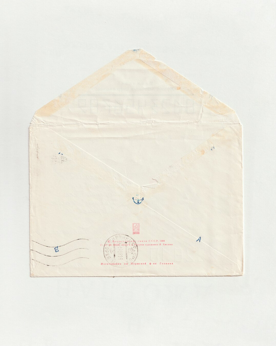Handwritten letter with envelope and stamps on a desk